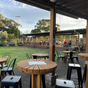 Outdoor seating area with lawn and tables