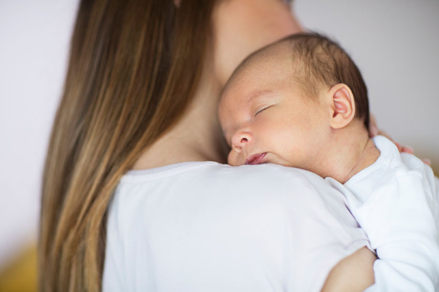 Newborn on mother's shoulder