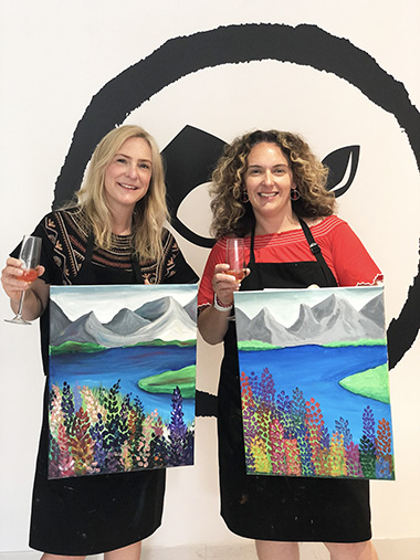 Inner West Mums team holding finished paintings 