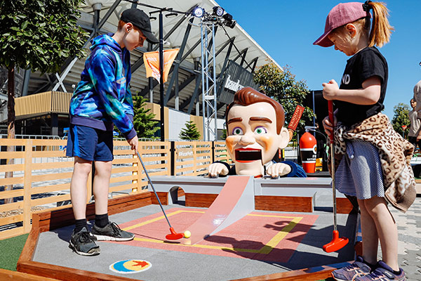 Kids playing mini golf